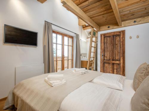 a bedroom with a bed and a tv on the wall at Chalet Cornelia in Gatschberg