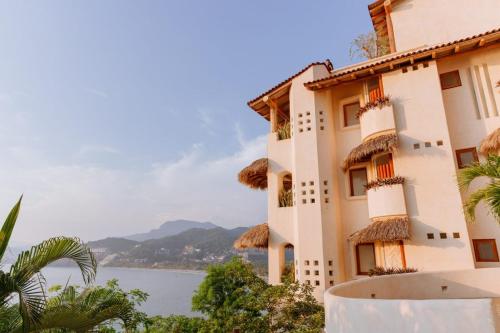 a building with a view of the water at Pacífica Grand Zihuatanejo in Zihuatanejo