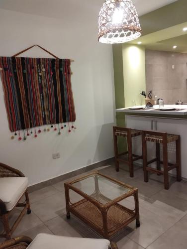 a room with a table and chairs and a sink at JAZCA Huayco in San Salvador de Jujuy
