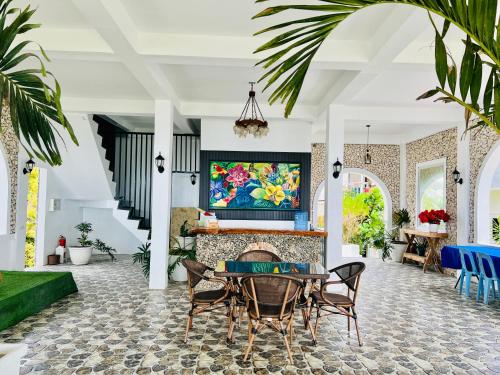 a living room with a table and chairs and a fireplace at Oceano con Vista Mountain Resort in Tagbaobo