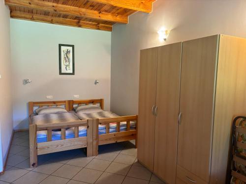 a bedroom with two bunk beds and a closet at k.e.m.p. inn in Krzycko Małe