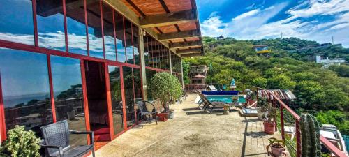 a balcony of a house with a view of the mountains at Mar en Casa - Taganga - Vista al Mar in Taganga
