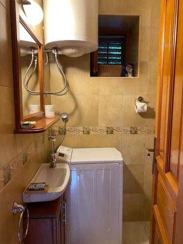 a bathroom with a sink and a mirror at Charming Stone Cottage Kotor in Kotor