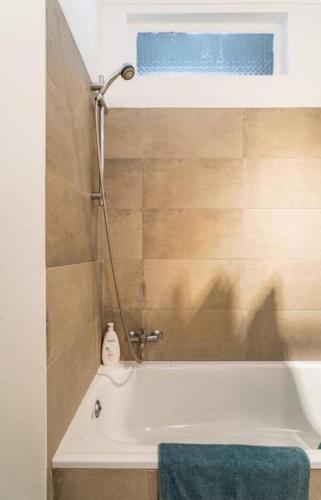 a bathroom with a bath tub with a shower at Casa da Matilde in Estoril