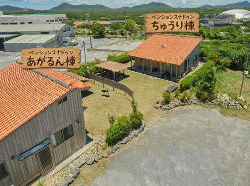 an overhead view of a house withinese writing on its roofs at Pension Snadun in Ginoza
