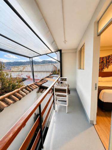a room with a view of a bedroom and a bed at Cusco - Perú "Hotel Boutique Qorikallpa" The true essence of inka culture in Cusco