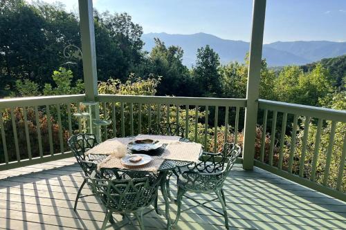 a table and two chairs on a porch with a view at Mountain View Paradise by Avada Properties in Gatlinburg