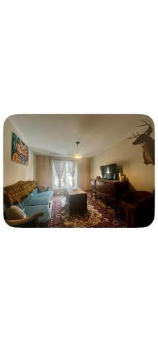 a living room with a bed and a desk at Chalet Havana in Namur