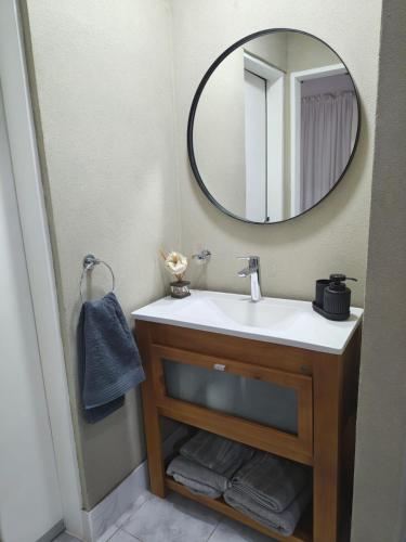 a bathroom with a sink and a mirror at Quimey Ruca Alojamientos in Neuquén