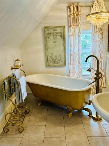 a bathroom with a large tub and a sink at 1000 Islands Bed and Breakfast-The Bulloch House in Gananoque