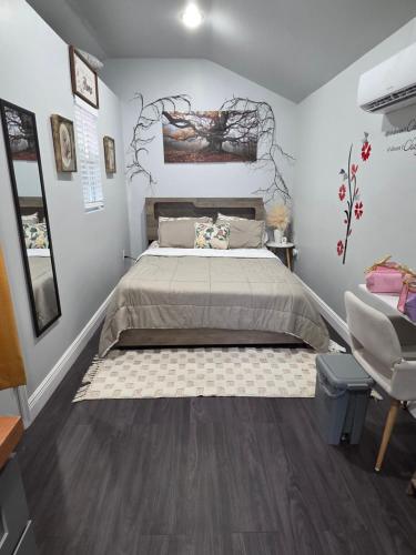 a bedroom with a large bed and a chair at Ranch style tiny home retreat Near Downtown Orlando in Orlando