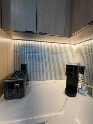 a kitchen with a counter top with a toaster and a toaster at Atl oasis in Atlanta