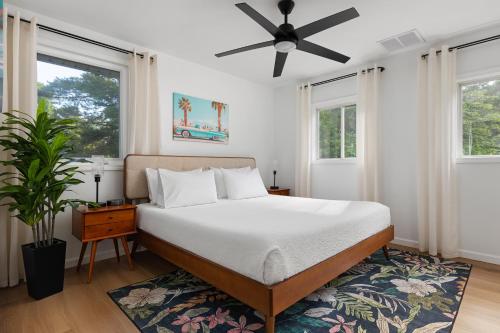 a bedroom with a bed and a ceiling fan at Sun & Sand Resort in Port Austin