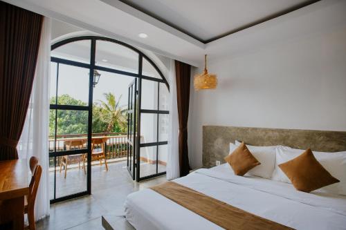 a bedroom with a bed and a balcony at Nuansa Penida Hostel in Nusa Penida