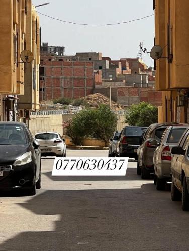 a parking lot with parked cars in a city at مستغانم حي السلام المجدوب in Sidi Mohammed Medjoub