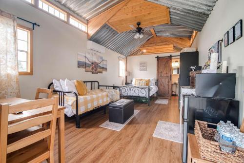 a living room with a couch and a tv at Hill Country Cabin 1 in Canyon Lake