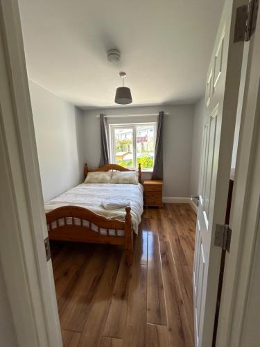 a bedroom with a bed and a window at Teach Fáilte in Sligo