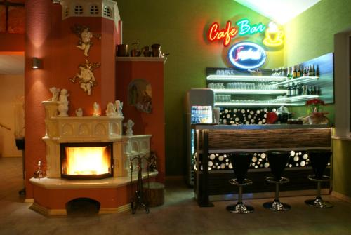 a bar with a fireplace in a store at Hotel Krak in Myślenice