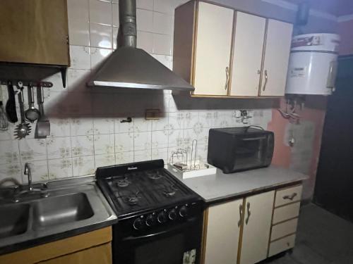 a small kitchen with a stove and a sink at Casa Chicho in Santiago del Estero