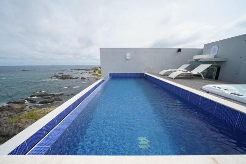 a swimming pool with a view of the ocean at Pohang Horizon Poolvilla in Pohang