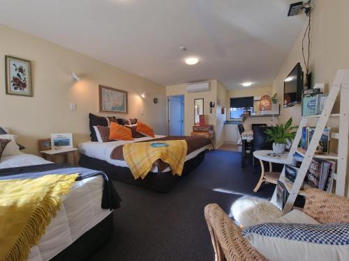 a bedroom with two beds and a living room at #6 Glenorchy Alpine Suite in Glenorchy