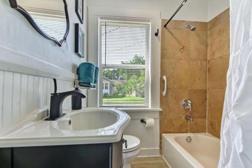 a bathroom with a sink and a tub and a toilet at Charming St Augustine Oasis with Game Room for Family fun in St. Augustine