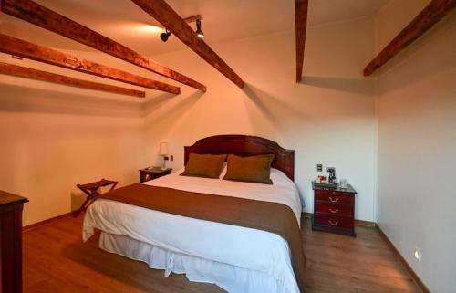 a bedroom with a large bed in a room at Hotel Boutique Casona Violeta in San Carlos