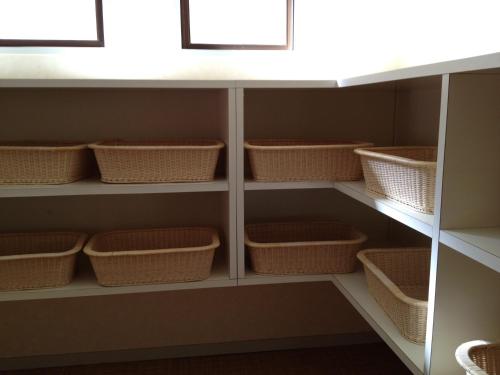 a walk in pantry with wicker baskets at Iyashinoyado Rodem in Morioka