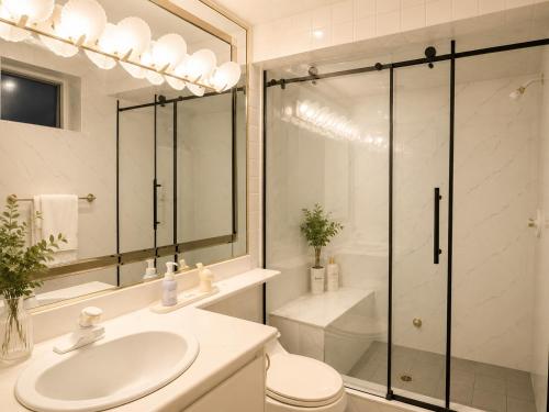 a bathroom with a shower and a sink and a toilet at Van Nest near YVR UBC Downtown Free Parking in Vancouver