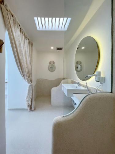 a bathroom with a sink and a mirror at Villa Sei Uluwatu by LODGELINK BALI in Uluwatu