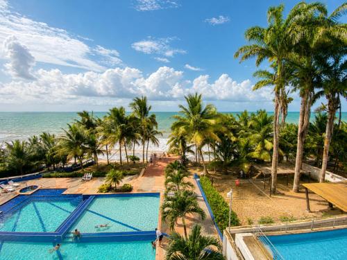 an aerial view of the beach and pool at the resort at Playa Azul Exclusive Suites in Tonsupa