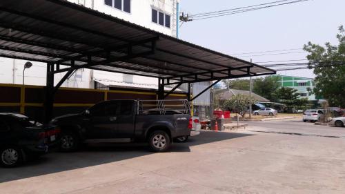 a black truck parked in a parking lot at Berich Hotel in Tak