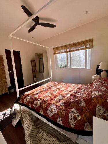 a bedroom with a bed and a ceiling fan at Villa Patria in Calatagan