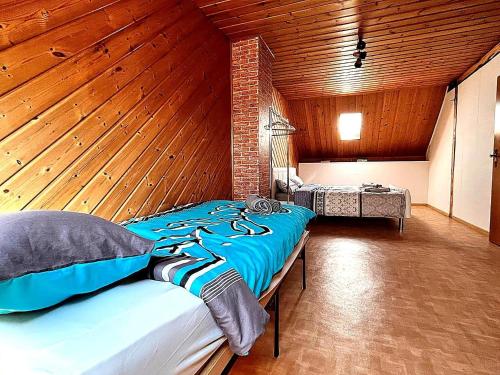 a bedroom with a large bed in a room with wooden walls at Holiday Home in Badem in Badem