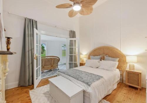 a bedroom with a bed and a ceiling fan at Cork Hill Retreat in Cape Bridgewater
