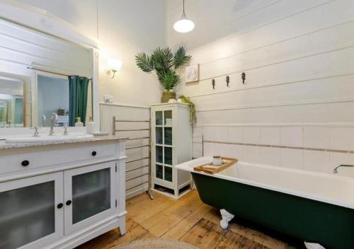 a bathroom with a large tub and a sink at Cork Hill Retreat in Cape Bridgewater