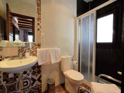 a bathroom with a toilet and a sink at Beautiful villa with jacuzzi in Canillas de Albaida