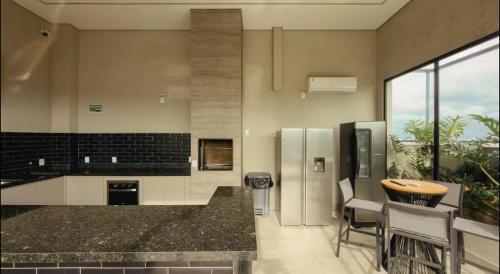 a kitchen with stainless steel appliances and a counter top at Studio próximo a UFU Sta Monica e Center shopping in Uberlândia