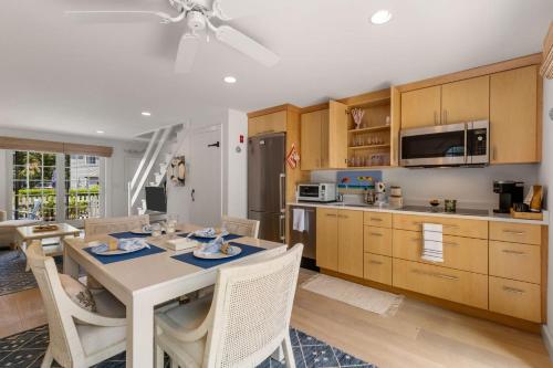 a kitchen with a table and chairs in a room at Hydrangea Lane Beach Cottage in Mashpee