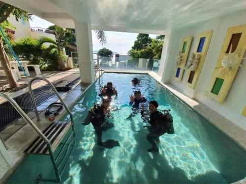 a group of people in a swimming pool at Casa Bahia Dive Resort in Mabini
