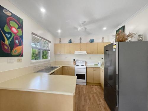 a kitchen with a refrigerator and a stove at Gigi's Getaway in Horseshoe Bay