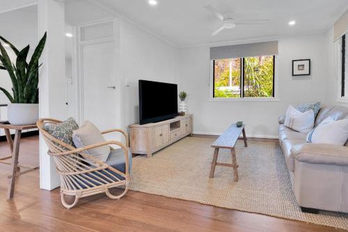 a living room with a couch and a tv at Birdwing Retreat in Picnic Bay
