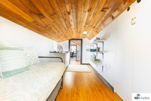 a bedroom with a bed and a wooden ceiling at Waterfront Zen-Dock, Paddleboards, Jacuzzi & Games in St. Augustine