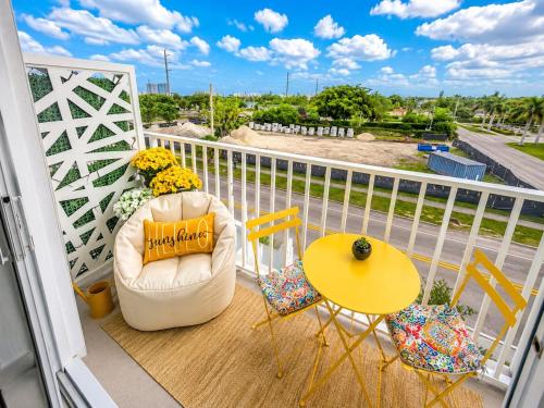 a balcony with a chair and a table and a table and chairs at Coastal Retreat Near Hollywood Beach & Casinos in Hallandale Beach