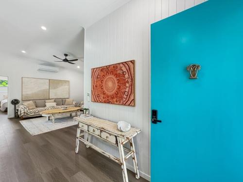 a living room with a table and a couch at Tropic 21 in Picnic Bay