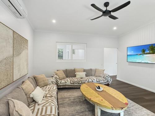 a living room with a couch and a table at Tropic 21 in Picnic Bay