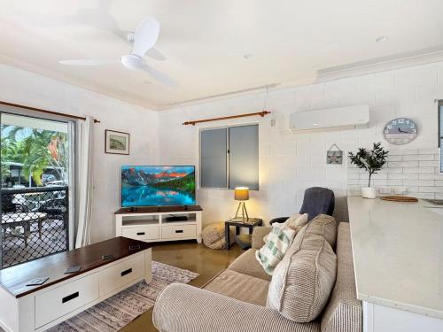 a living room with a couch and a flat screen tv at Runswick in Horseshoe Bay