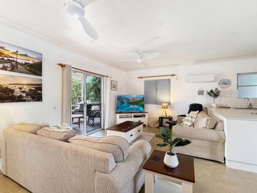 a living room with two couches and a kitchen at Runswick in Horseshoe Bay