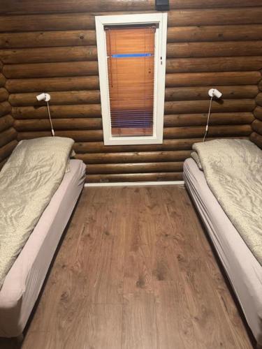 a room with two beds and a window at Øse Camping in Gratangen
