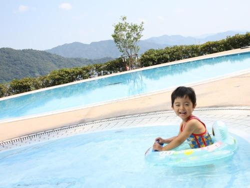 a young boy in a swimming pool at Grand Prince Hotel Hiroshima in Hiroshima